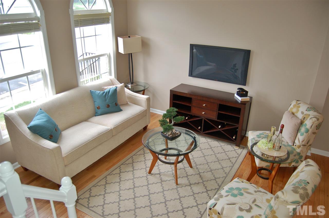4713 Longhill Lane Raleigh, NC 27612 - Photo 3 of 18 a living room with furniture a window and a potted plant