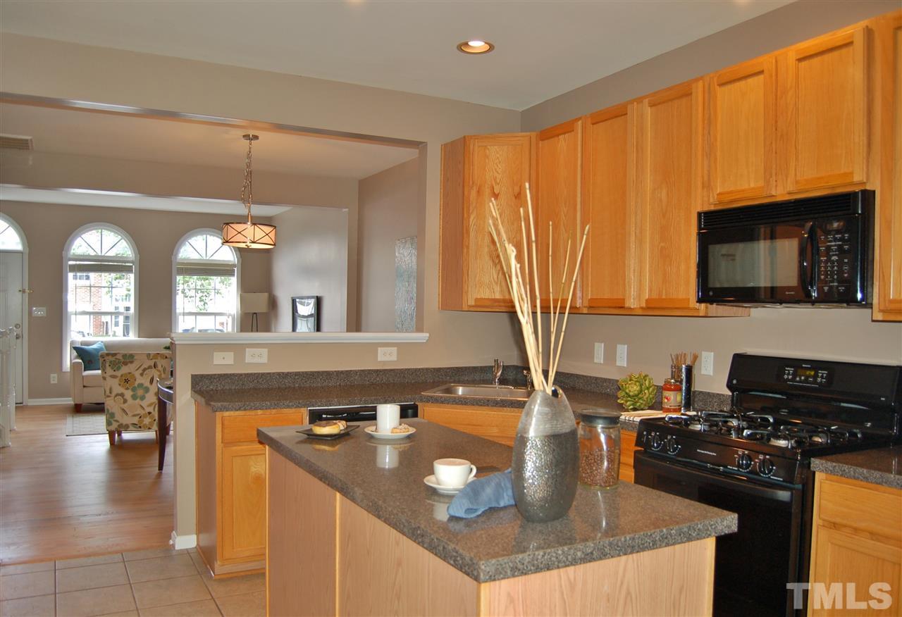 4713 Longhill Lane Raleigh, NC 27612 - Photo 6 of 18 a kitchen with a stove a sink and a microwave