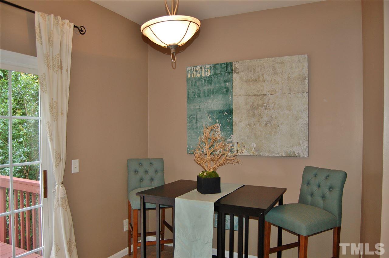 4713 Longhill Lane Raleigh, NC 27612 - Photo 7 of 18 a table and chairs in a small room