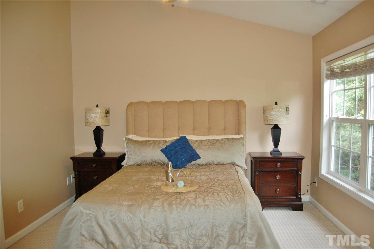 4713 Longhill Lane Raleigh, NC 27612 - Photo 9 of 18 a bedroom with a bed and a dresser