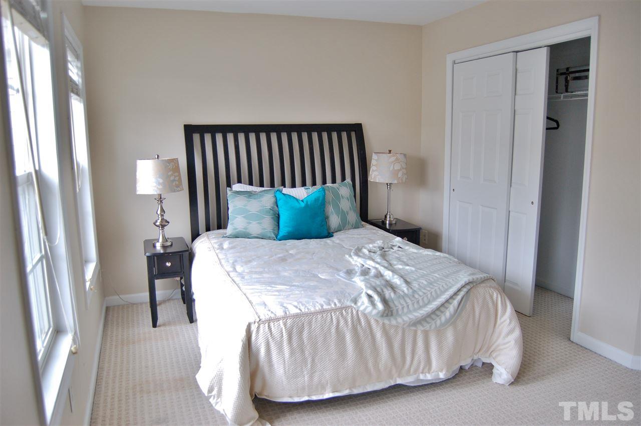 4713 Longhill Lane Raleigh, NC 27612 - Photo 10 of 18 a bedroom with a bed and wooden floor