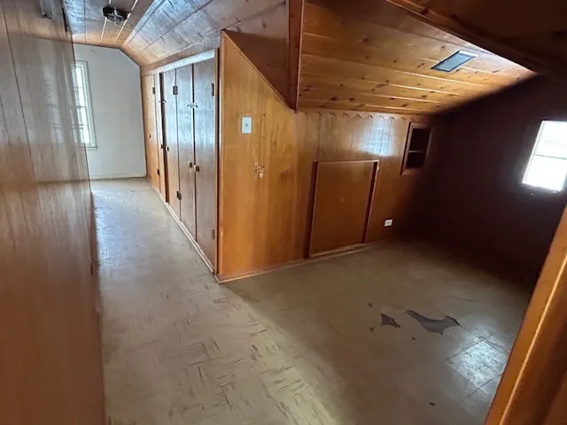 a view of a hallway with wooden shelves