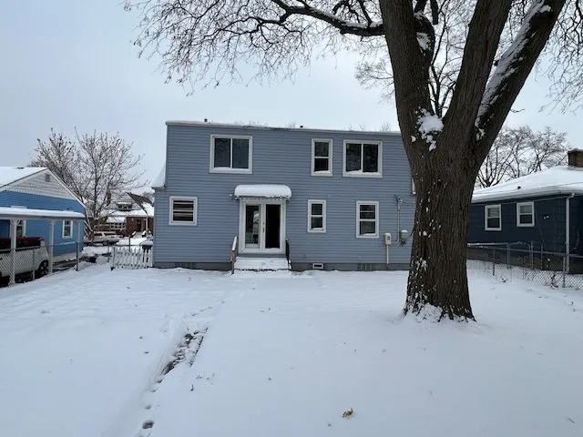 a view of a house with a tree in the background