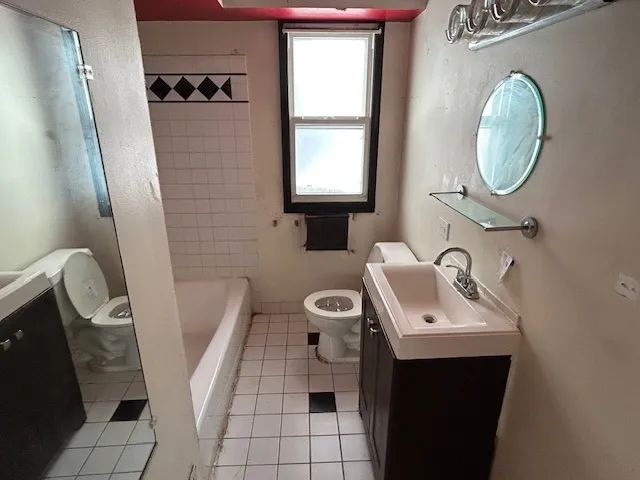 a bathroom with a toilet a sink and a mirror