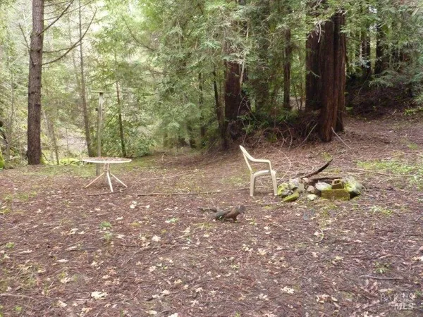 a backyard of a house with table and chairs