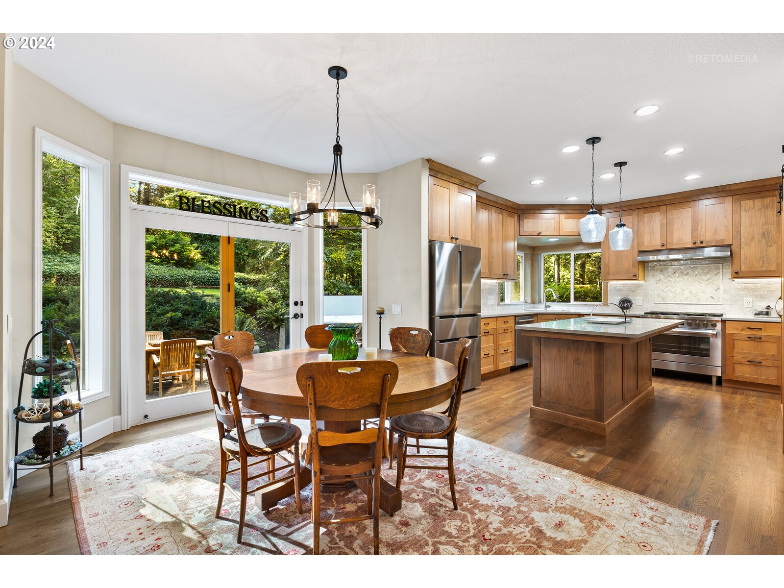 14523 Southwest Bell Road Sherwood, OR 97140 - Photo 14 of 48 a view of a dining room and livingroom with furniture wooden floor a chandelier