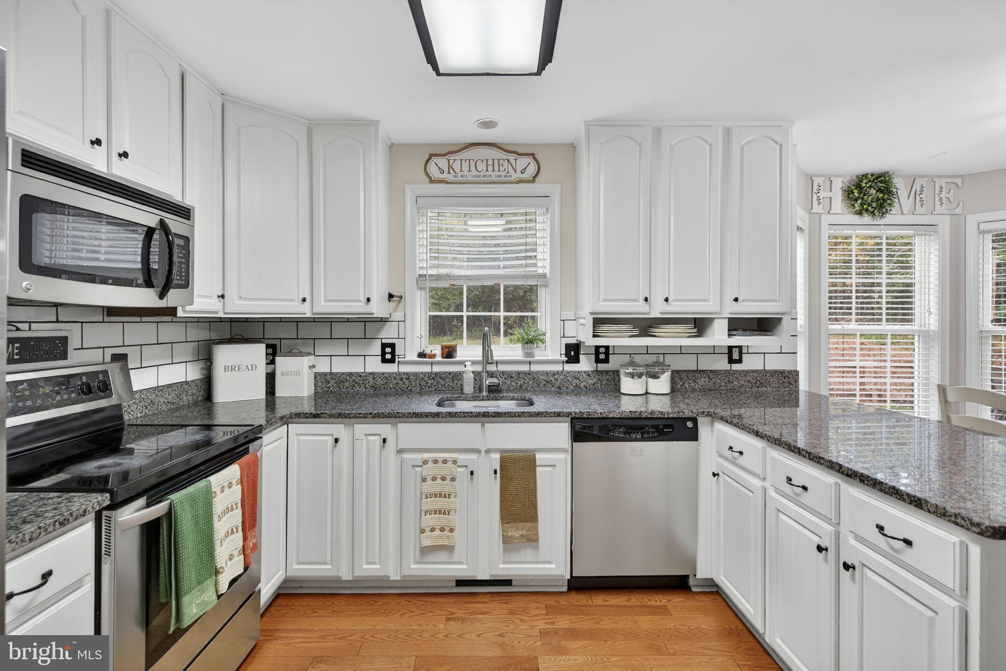 10277 River Road Rixeyville, VA 22737 - Photo 13 of 32 a kitchen with stainless steel appliances granite countertop a stove sink and cabinets