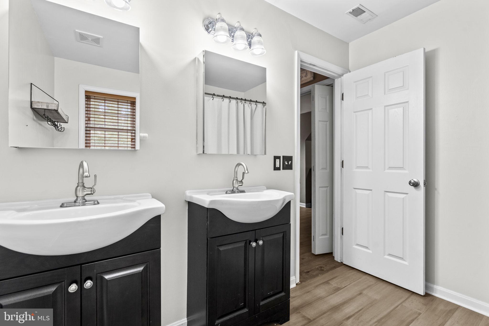 10277 River Road Rixeyville, VA 22737 - Photo 22 of 32 a bathroom with a sink double vanity and a mirror