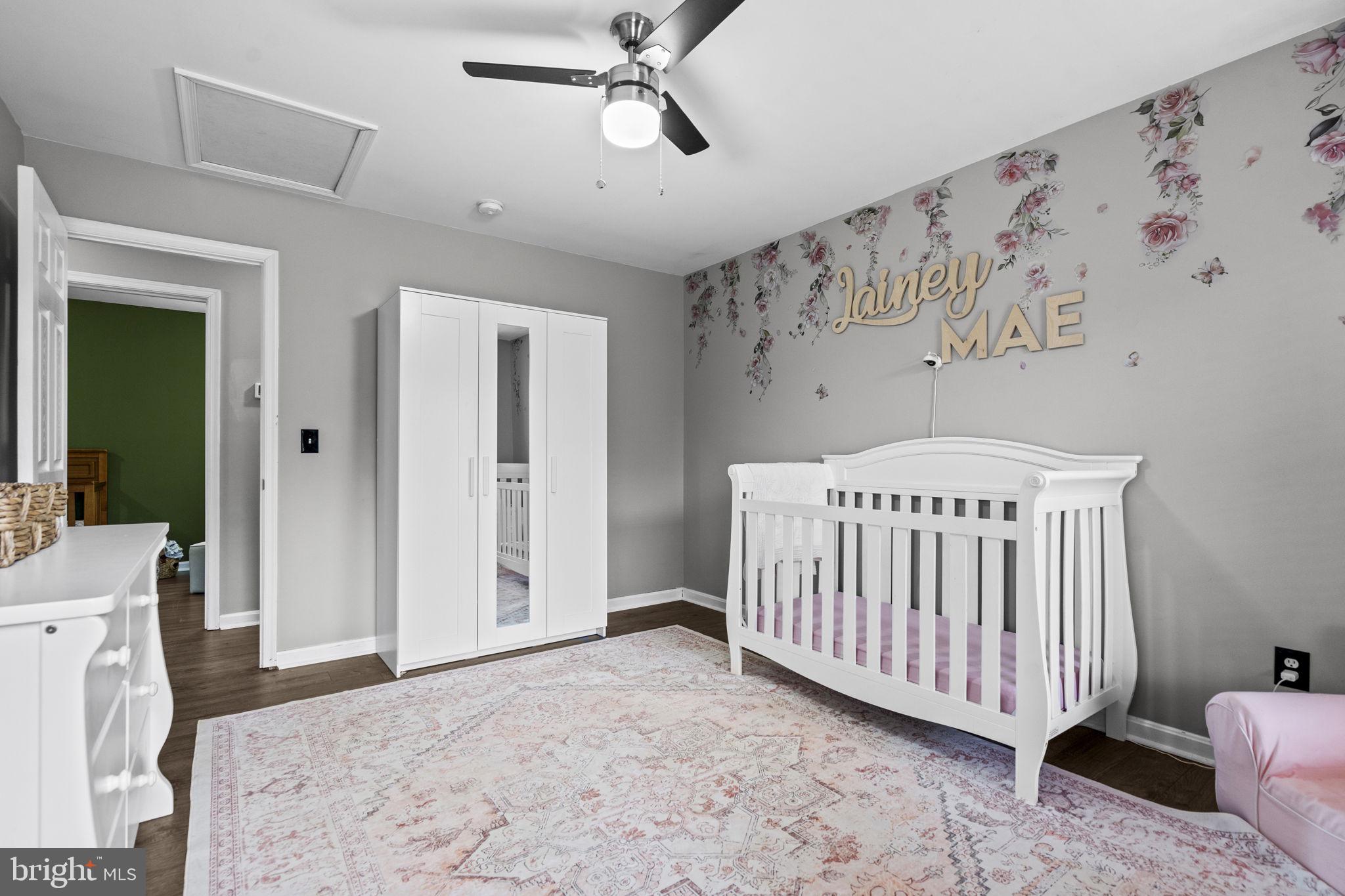 10277 River Road Rixeyville, VA 22737 - Photo 26 of 32 a bedroom with a baby bed a couch and a window