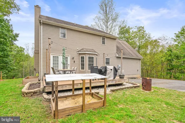 a view of a house with backyard and sitting area