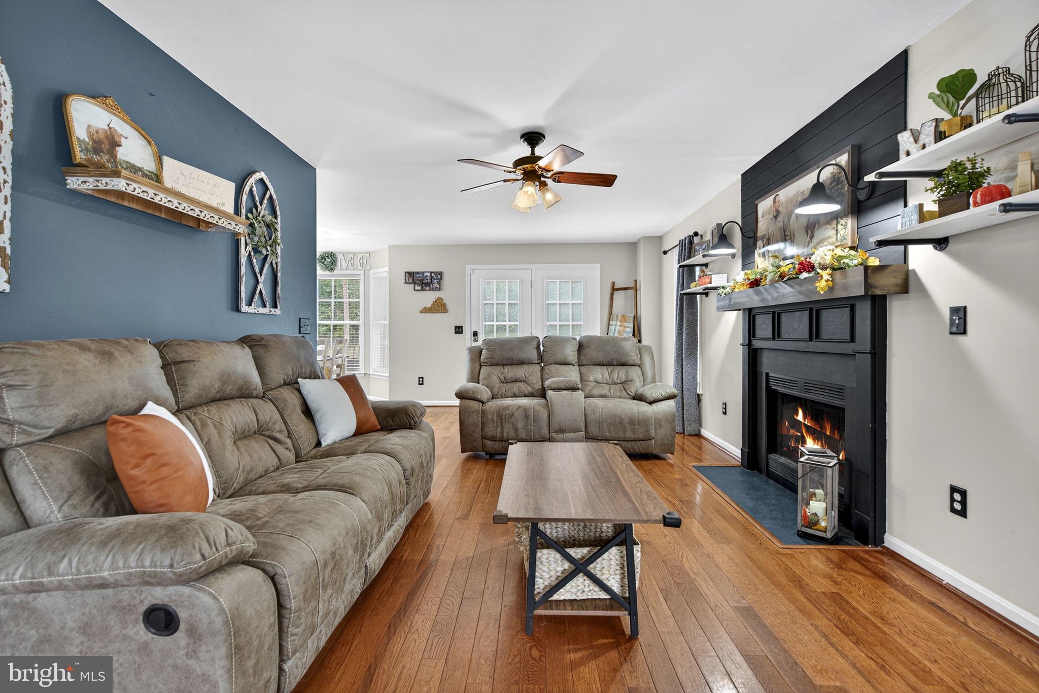 10277 River Road Rixeyville, VA 22737 - Photo 6 of 32 a living room with furniture a fireplace and a flat screen tv