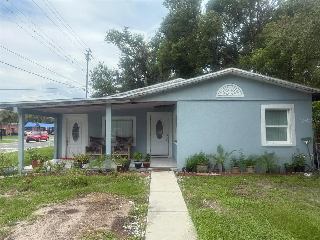 1509 Neil Street Plant City, FL 33563 - Photo 1 of 14 a front view of a house with garden