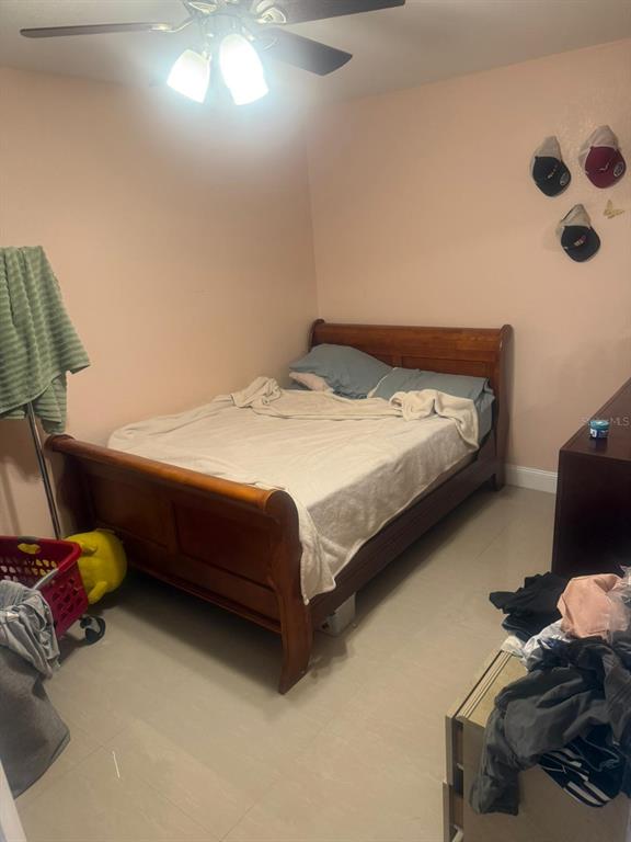 1509 Neil Street Plant City, FL 33563 - Photo 11 of 14 a bedroom with a bed and a chair