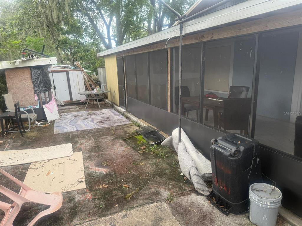 1509 Neil Street Plant City, FL 33563 - Photo 14 of 14 a view of a backyard with chairs and a large tree