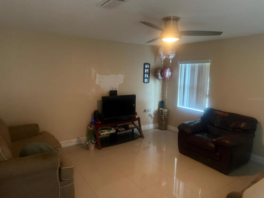 1509 Neil Street Plant City, FL 33563 - Photo 4 of 14 a living room with furniture and a flat screen tv