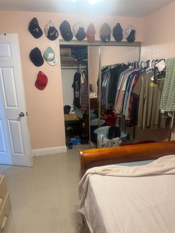 1509 Neil Street Plant City, FL 33563 - Photo 5 of 14 a view of walk in closet with clothes and shoes