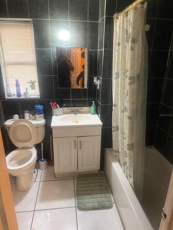 1509 Neil Street Plant City, FL 33563 - Photo 6 of 14 a bathroom with a sink toilet and shower