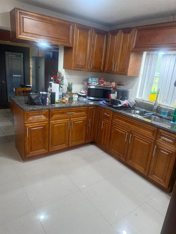1509 Neil Street Plant City, FL 33563 - Photo 7 of 14 a kitchen with stainless steel appliances granite countertop a sink dishwasher stove and cabinets