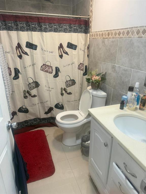 1509 Neil Street Plant City, FL 33563 - Photo 10 of 14 a white toilet sitting next to a bathroom sink