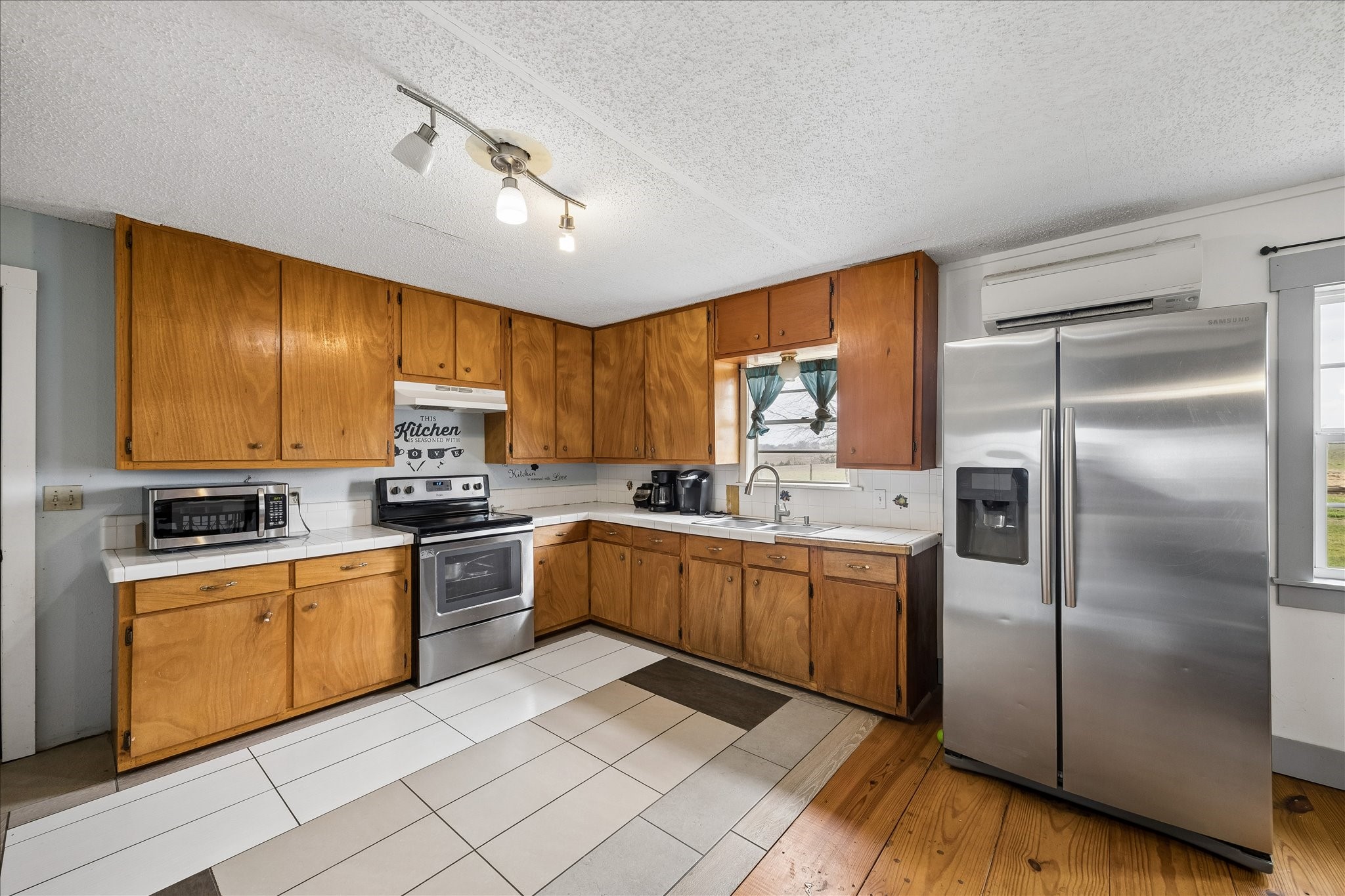 4435 Hartfield Road Round Top, TX 78954 - Photo 17 of 20 a kitchen with a sink stainless steel appliances and cabinets