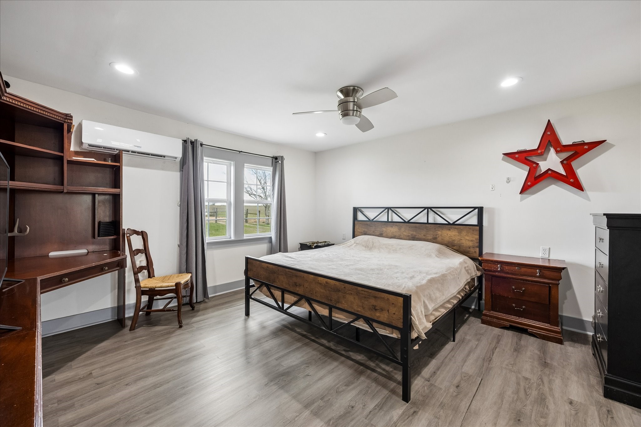 4435 Hartfield Road Round Top, TX 78954 - Photo 18 of 20 a bedroom with a bed and a chandelier