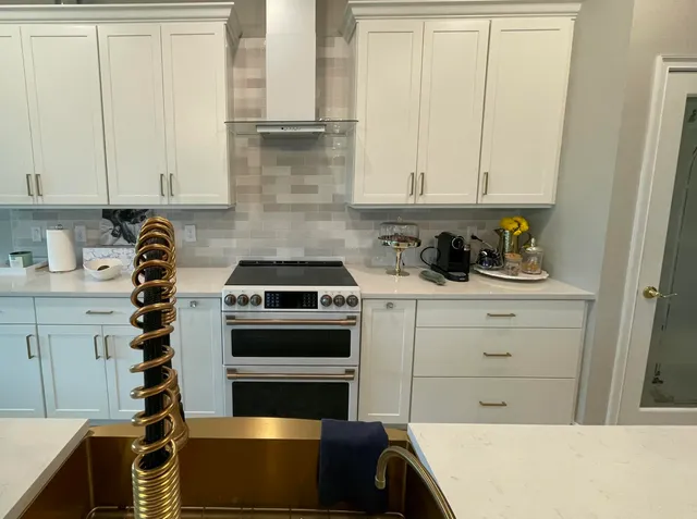 a view of a patio with couches chairs and a floor to ceiling window