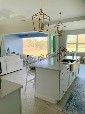 a view of a porch with furniture and a yard