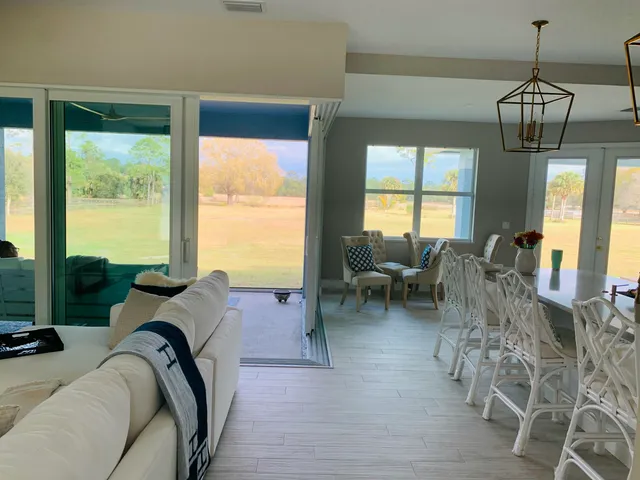 a view of a backyard with swimming pool and outdoor seating