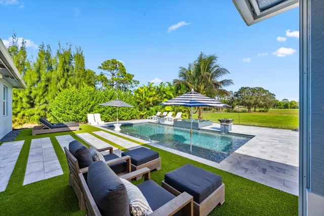a view of a swimming pool with a lounge chairs