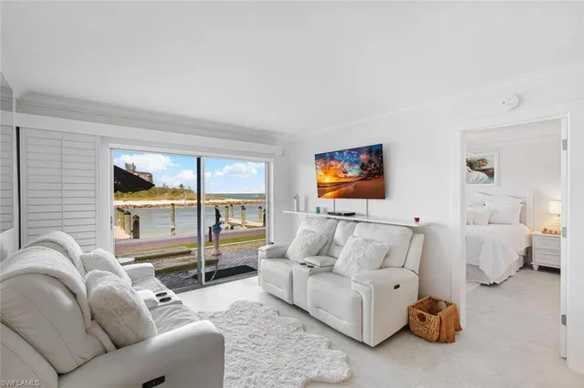 a living room with furniture a couch and a flat screen tv