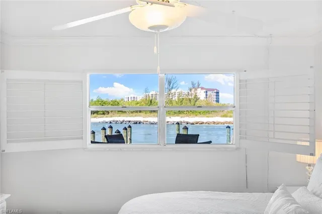 a living room with a large window and a table