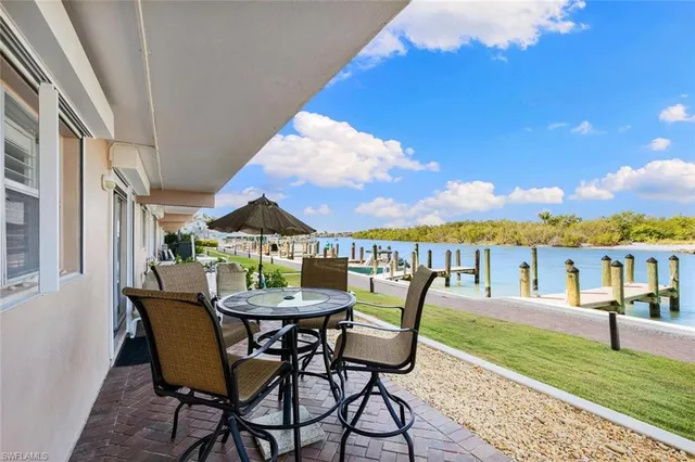 a table and chairs in front of a house