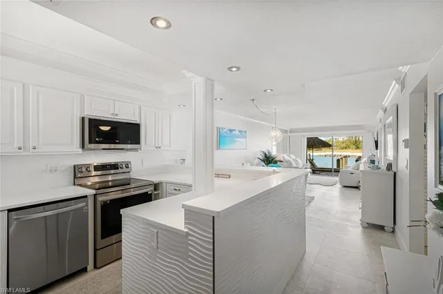 a kitchen with stainless steel appliances a stove sink and microwave