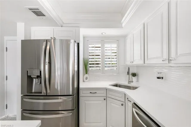 a kitchen with appliances cabinets and a sink