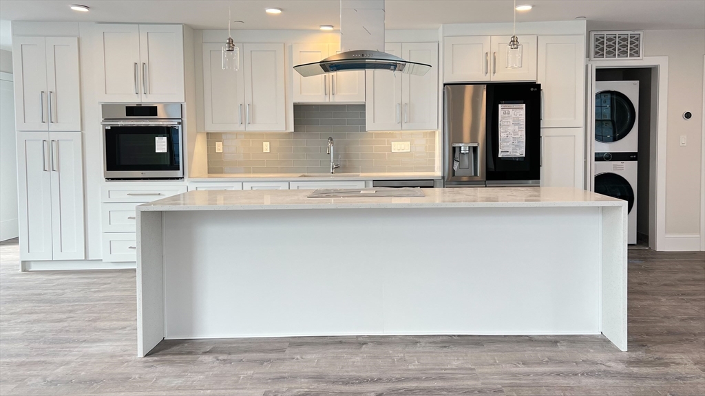 131 Cambridge Street, Unit A Burlington, MA 01803 - Photo 14 of 22 a kitchen with stainless steel appliances granite countertop a refrigerator and a stove top oven