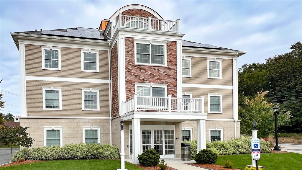 131 Cambridge Street, Unit A Burlington, MA 01803 - Photo 4 of 22 a front view of a house with a garden