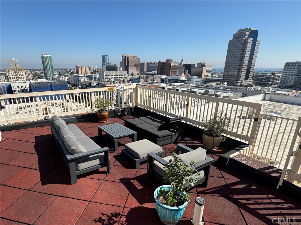 315 West 3rd Street, Unit 305 Long Beach, CA 90802 - Photo 17 of 19 a view of a balcony with two chairs and a potted plant