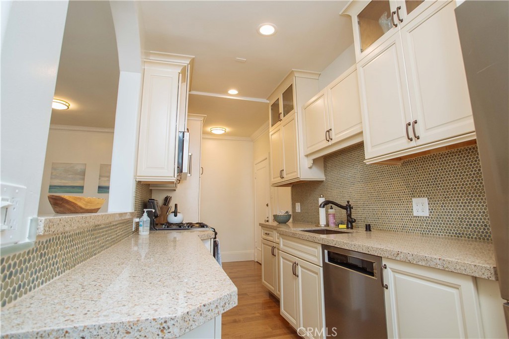 315 West 3rd Street, Unit 305 Long Beach, CA 90802 - Photo 6 of 19 a kitchen with stainless steel appliances granite countertop a sink a stove and a refrigerator