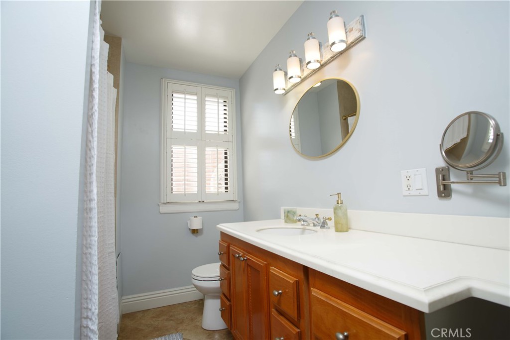 315 West 3rd Street, Unit 305 Long Beach, CA 90802 - Photo 9 of 19 a bathroom with a toilet sink and mirror