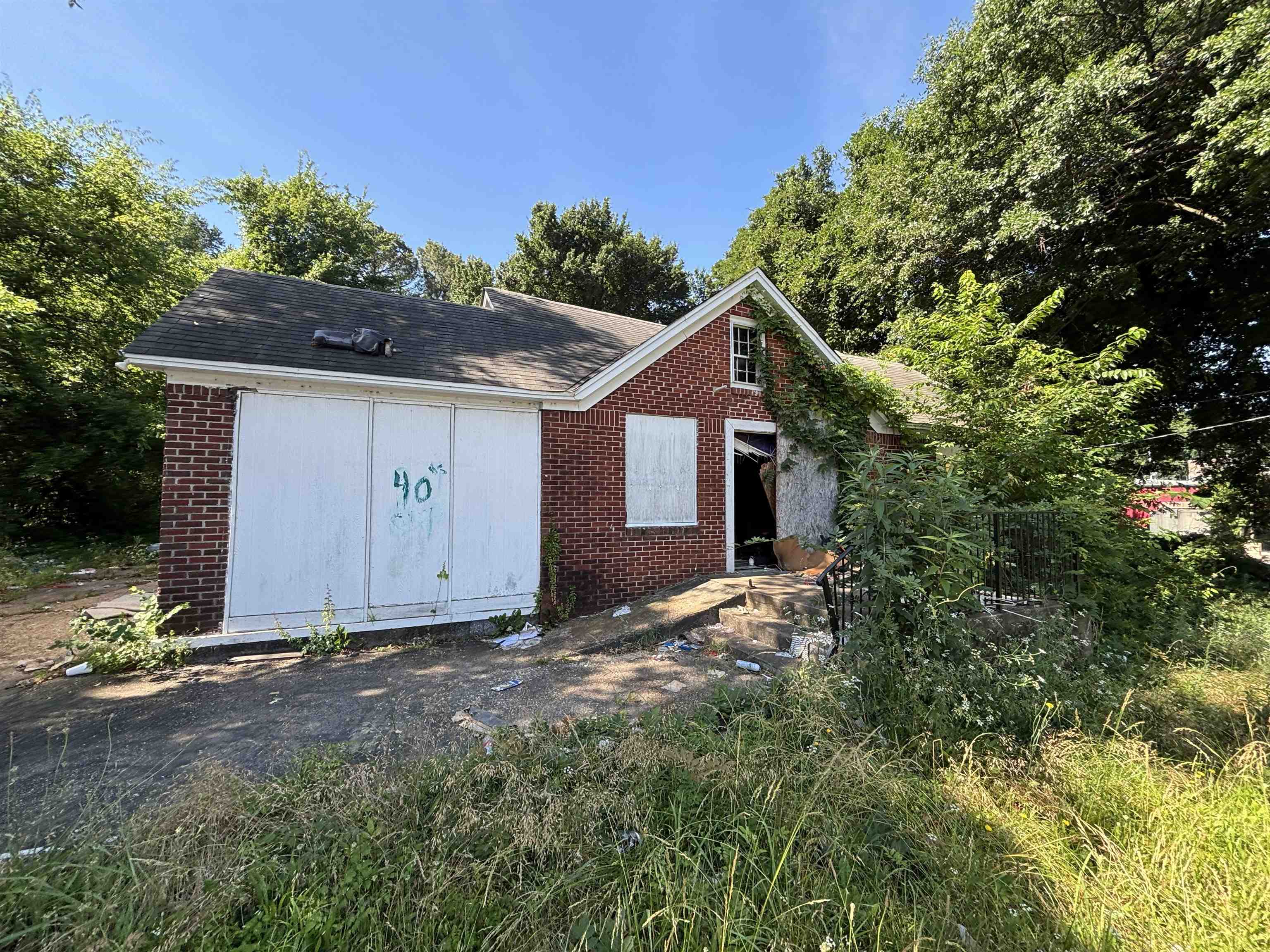 175 East Brooks Road Memphis, TN 38109 - Photo 1 of 7 Brick exterior residence featuring a gabled roofline and an attached structure with white paneling