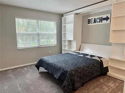 a bedroom with bed and window