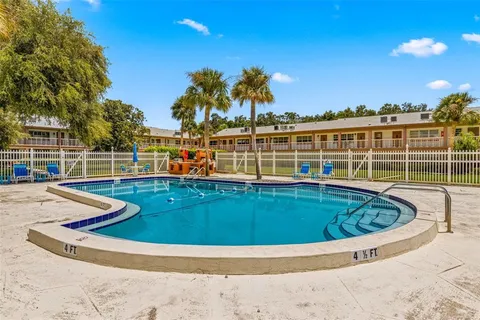 a view of a swimming pool with a lounge chairs