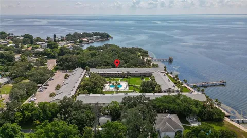an aerial view of a house yard swimming pool and outdoor seating