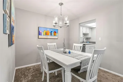 a view of a dining room with furniture wooden floor and a chandelier