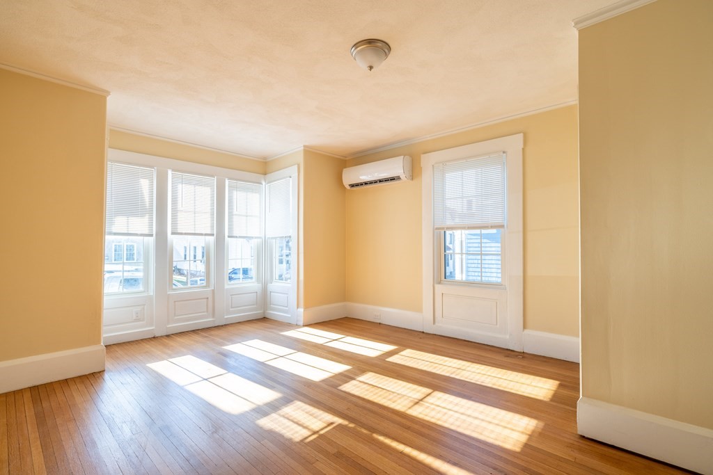268 Locust Street Fall River, MA 02720 - Photo 19 of 38 a view of an empty room with wooden floor and a window
