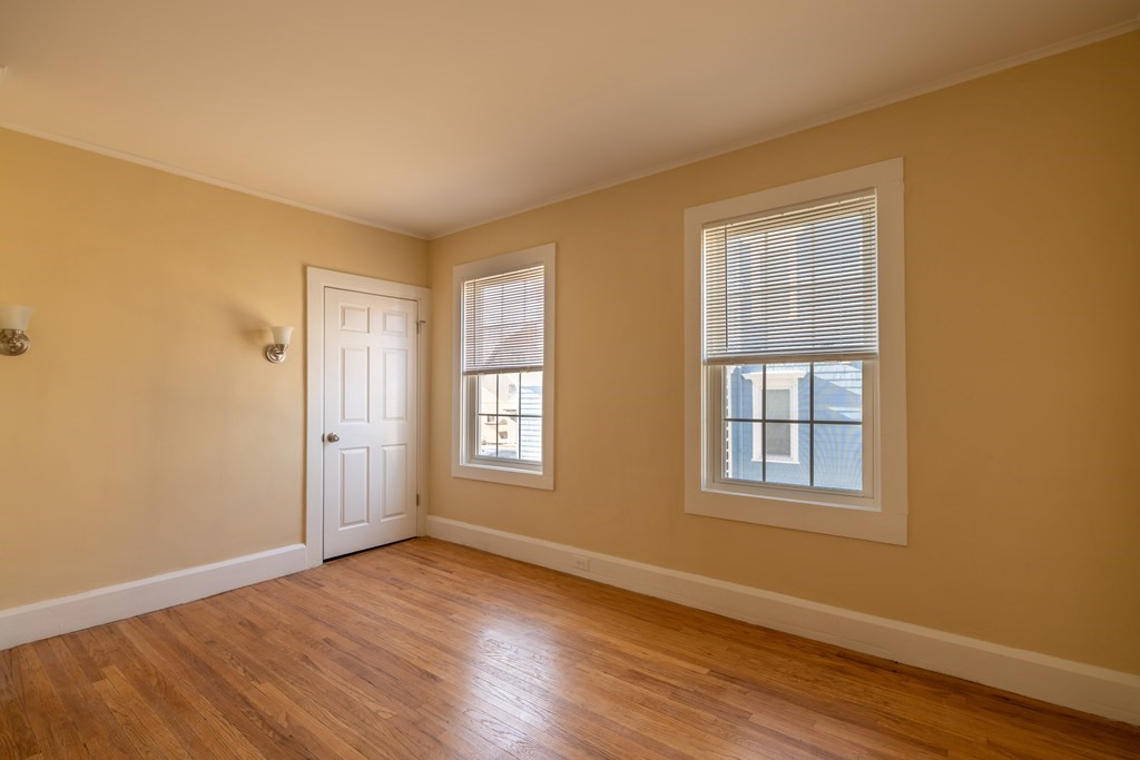 268 Locust Street Fall River, MA 02720 - Photo 22 of 38 a view of an empty room with wooden floor and a window