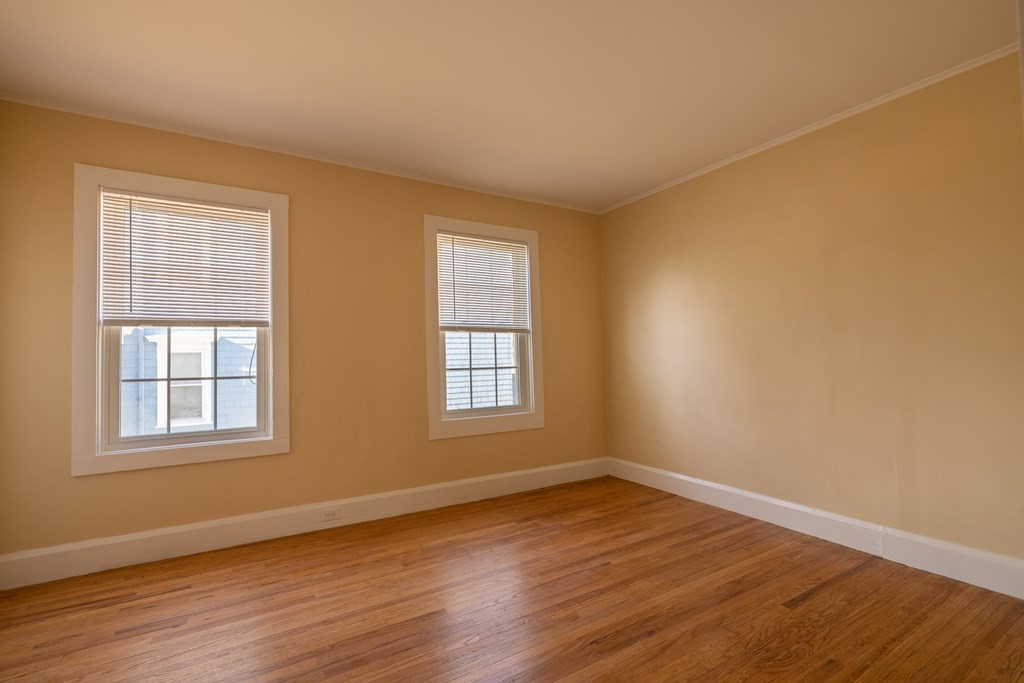 268 Locust Street Fall River, MA 02720 - Photo 23 of 38 a view of an empty room with wooden floor and a window