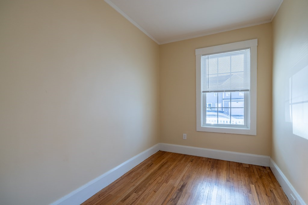 268 Locust Street Fall River, MA 02720 - Photo 24 of 38 a view of an empty room with wooden floor and a window