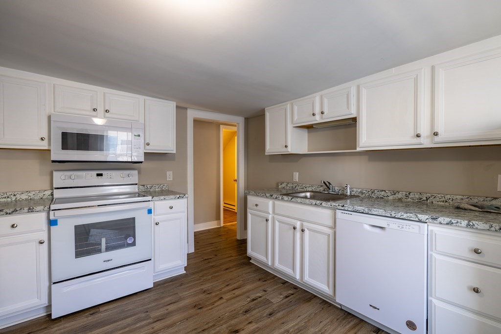 268 Locust Street Fall River, MA 02720 - Photo 29 of 38 a kitchen with granite countertop white cabinets and white appliances