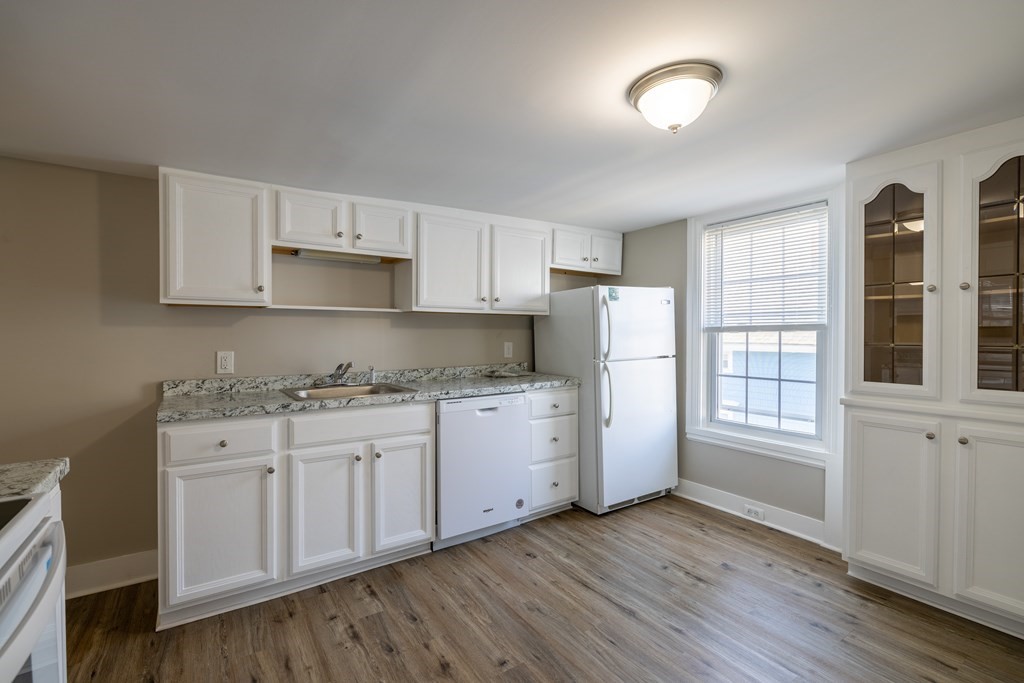 268 Locust Street Fall River, MA 02720 - Photo 30 of 38 a kitchen with granite countertop white cabinets and white appliances